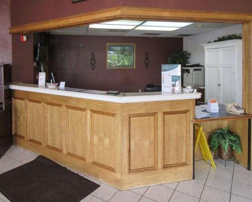 a large wooden counter in a kitchen with a counter top at Rodeway Inn in San Juan