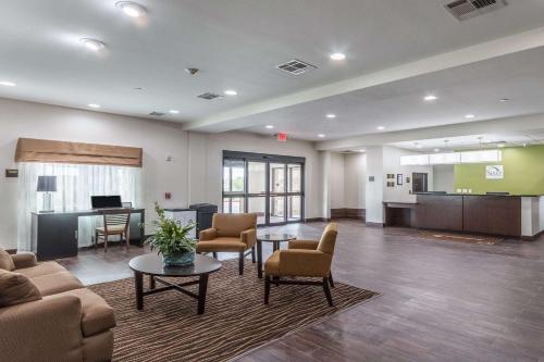 a living room with a couch and chairs and a table at Sleep Inn & Suites College Station near University in College Station