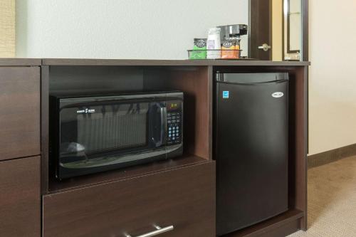 a microwave and a refrigerator in a cabinet at Sleep Inn & Suites Ingleside - Corpus Christi in Ingleside