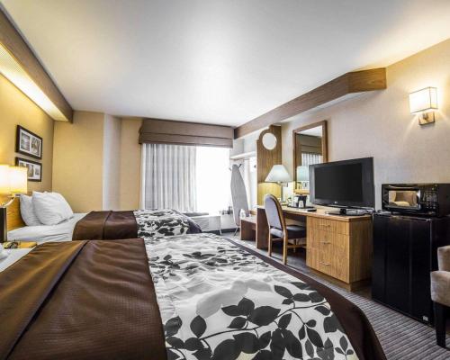a hotel room with two beds and a television at Quality Inn Moab Slickrock Area in Moab