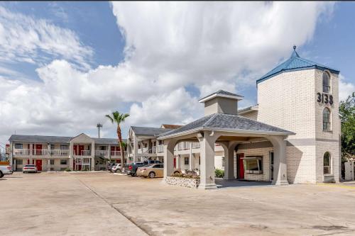 a church with a clock tower next to a parking lot at Summit Inn - Houston Medical Center - NRG Park in Houston