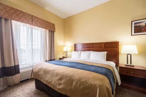a hotel room with a bed and a window at Comfort Inn & Suites in Cedar City