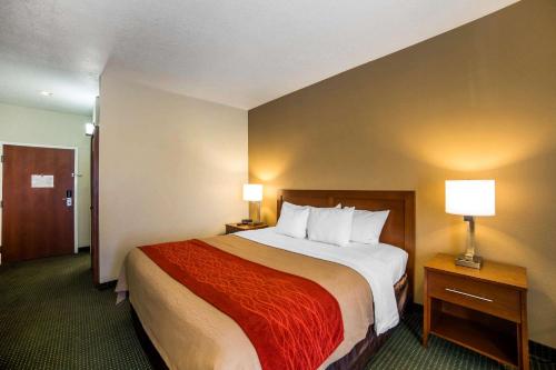 a hotel room with a large bed and two lamps at Quality Inn Draper near Salt Lake City in Draper