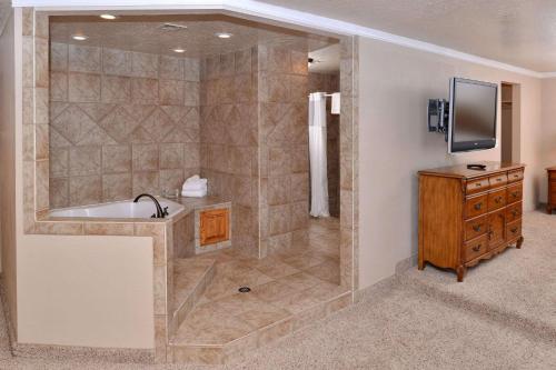 a large bathroom with a tub and a television at Quality Inn Vernal near Dinosaur National Monument in Vernal