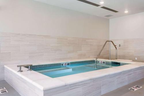 a large swimming pool in a white room at Comfort Inn & Suites Salt Lake City Airport in Salt Lake City