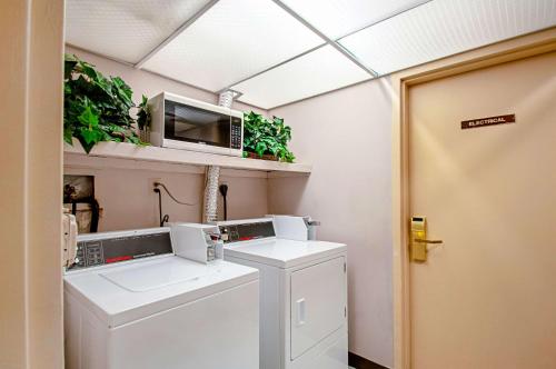 a laundry room with a washer and dryer at Econo Lodge Metro in Arlington