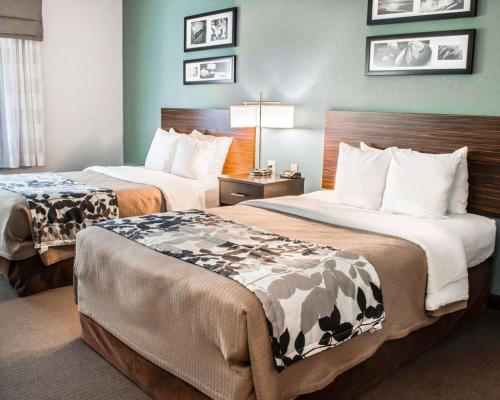 a hotel room with two beds in a room at Sleep Inn & Suites Monticello in Charlottesville