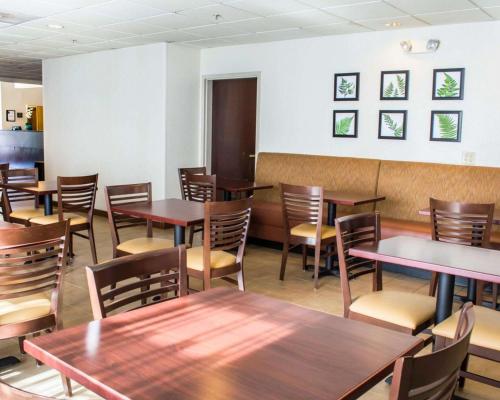 a dining room with wooden tables and chairs at Sleep Inn & Suites Monticello in Charlottesville