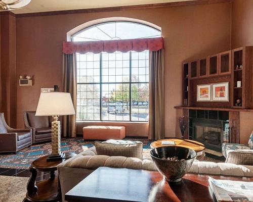 a living room with a large window and a couch at Comfort Suites Dulles Airport in Chantilly