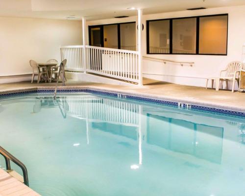 a pool in a hotel with chairs and a table at Sleep Inn & Suites Monticello in Charlottesville