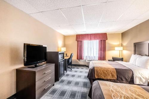 a hotel room with two beds and a flat screen tv at Comfort Inn Ballston in Arlington