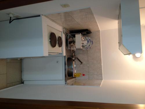 a small kitchen with blue cabinets and a sink at Konstantina Studios in Agios Nikitas