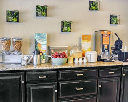a kitchen counter with fruits and vegetables on it at Quality Inn Thornburg in Thornburg