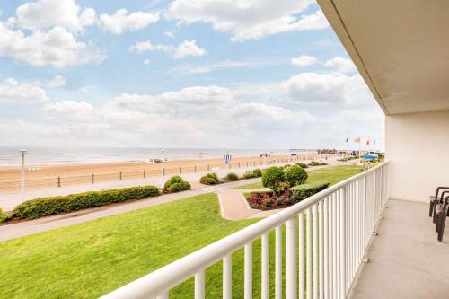 a balcony with a view of the beach at Coastal Hotel & Suites Virginia Beach - Oceanfront in Virginia Beach