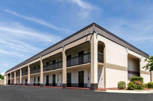 a large white building with a black roof at Quality Inn Lynchburg near University in Lynchburg