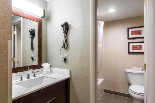 a bathroom with a sink and a toilet and a phone at Comfort Inn Newport News-Williamsburg East in Newport News