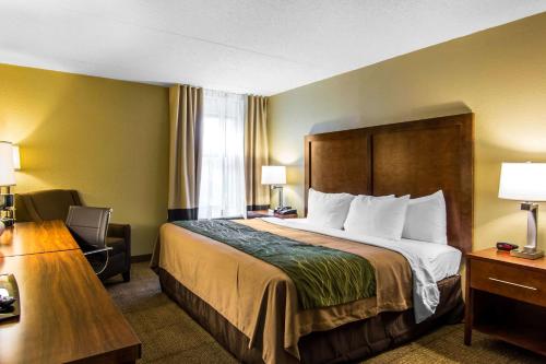 a hotel room with a bed and a desk at Quality Inn in Newport News