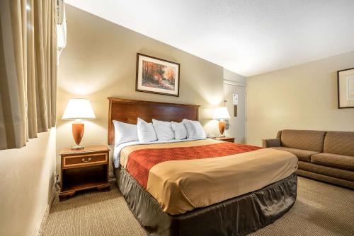 a hotel room with a bed and a couch at Holiday Lodge Yakima in Yakima