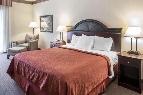 a hotel room with a bed and a chair at Holiday Inn - Clarkston - Lewiston, an IHG Hotel in Clarkston