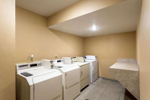 a laundry room with white washers and dryers at Quality Inn in Moses Lake