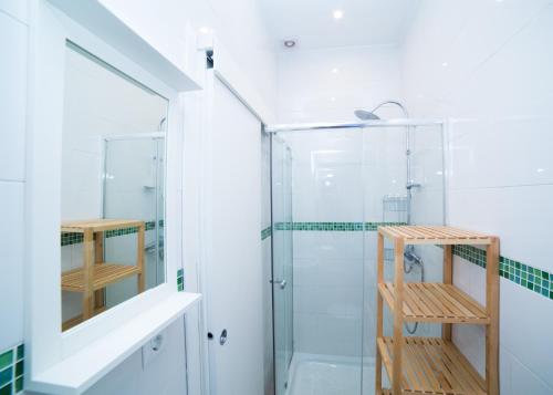 a bathroom with a shower and a glass shower stall at Casa Hernando Colón in Seville