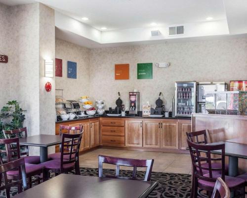a restaurant with tables and chairs and a refrigerator at Comfort Suites Wenatchee Gateway in Wenatchee