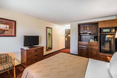 a hotel room with a bed and a flat screen tv at Quality Inn Othello in Othello
