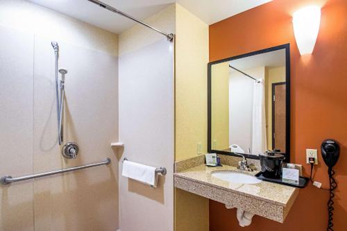 a bathroom with a sink and a mirror at Sleep Inn & Suites Madison - Monona in Madison