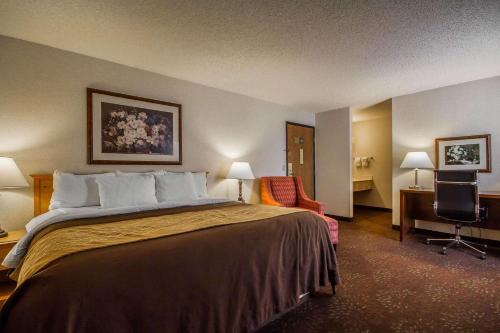 a hotel room with a bed and a desk at Comfort Inn Fond Du Lac in Fond du Lac