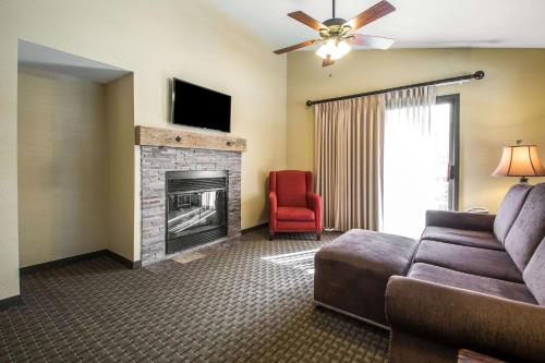 a living room with a couch and a fireplace at Bluegreen Vacations Christmas Mountain Village, an Ascend Collection Resort in Wisconsin Dells