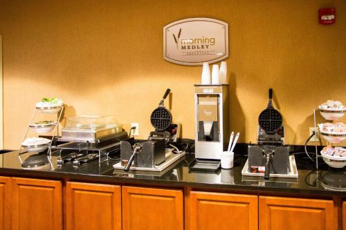 a kitchen with a counter with some food on it at Sleep Inn & Suites Conference Center Eau Claire North in Union