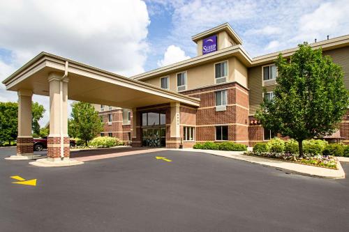 a hotel with a parking lot in front of it at Sleep Inn & Suites Madison - Monona in Madison