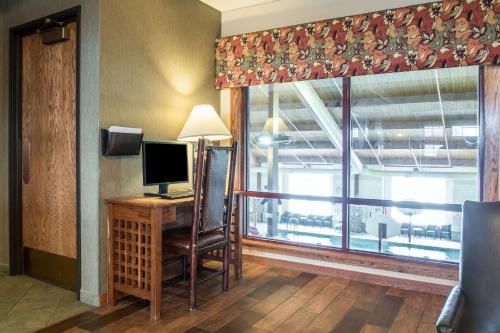 a room with a desk with a computer and a window at Bluegreen Vacations Christmas Mountain Village, an Ascend Collection Resort in Wisconsin Dells