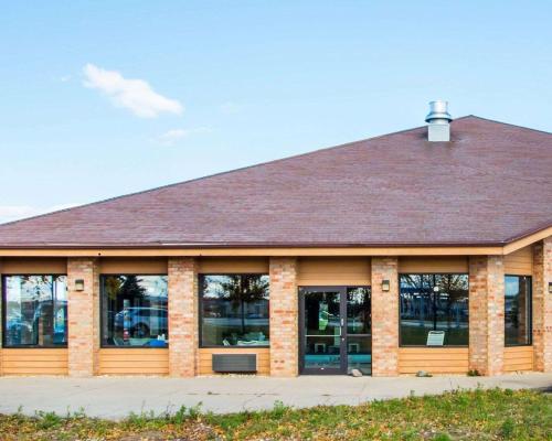 a building with windows and a brown roof at Quality Inn & Suites Kimberly - Appleton East in Kimberly