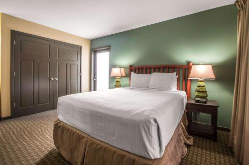 a bedroom with a large bed with green walls at Bluegreen Vacations Christmas Mountain Village, an Ascend Collection Resort in Wisconsin Dells