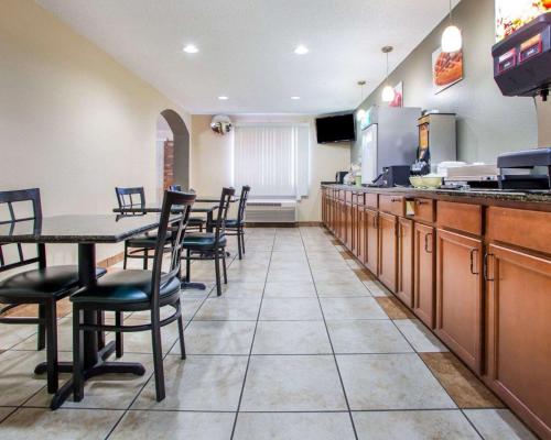 a restaurant with a table and chairs and a kitchen at Quality Inn & Suites Kimberly - Appleton East in Kimberly
