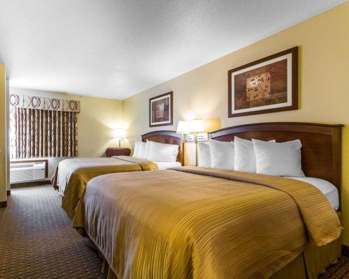 a hotel room with two beds and two lamps at Quality Inn La Crosse North in La Crosse