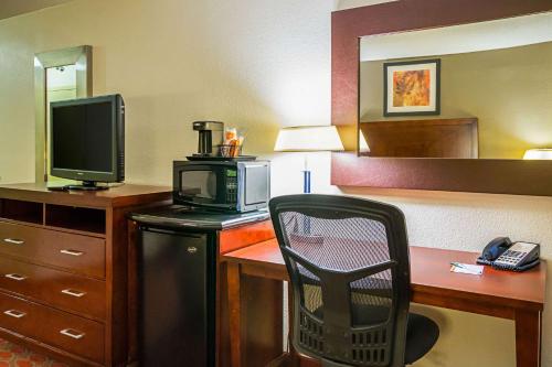 a hotel room with a desk with a television and a chair at Quality Inn Fairmont in Fairmont
