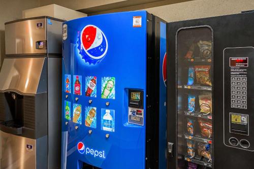 a blue vending machine next to a refrigerator at Quality Inn Fairmont in Fairmont