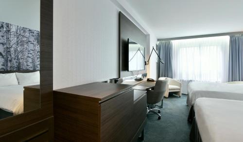 a hotel room with a desk and a bed at DoubleTree by Hilton Ottawa Downtown in Ottawa