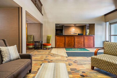 a lobby with a waiting area with couches and a podium at Quality Inn Fairmont in Fairmont