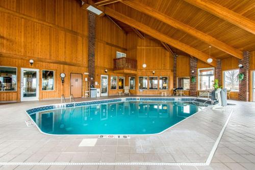 a large swimming pool in a building with a wooden ceiling at Comfort Inn Weirton in Weirton