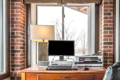 a computer sitting on a desk with a window at Comfort Inn in Weirton
