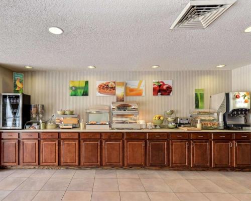 a large kitchen with wooden cabinets and appliances at Quality Inn Spring Mills - Martinsburg North in Martinsburg