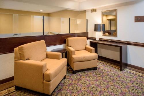 a waiting room with two chairs and a desk at Sleep Inn Charleston North in Charleston
