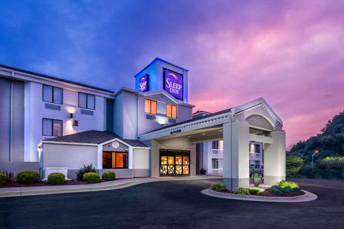 a hotel with a lit up sign on top of it at Sleep Inn Charleston North in Charleston