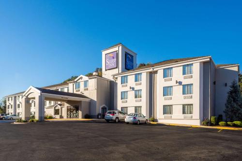 a hotel with cars parked in a parking lot at Sleep Inn Charleston North in Charleston