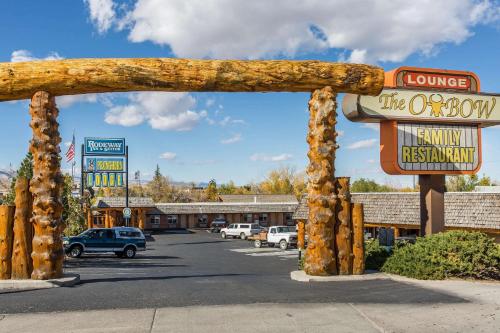 a sign for the okocooco motel in a parking lot at Rodeway Inn Pronghorn Lodge in Lander