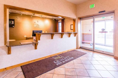 a lobby with a reception desk in a building at Quality Inn & Suites University in Laramie