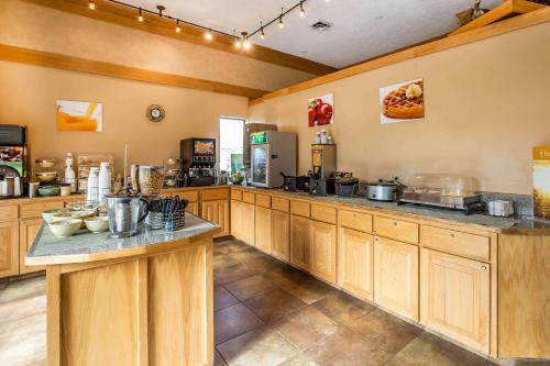 a large kitchen with wooden cabinets and a counter at Quality Inn in Rock Springs